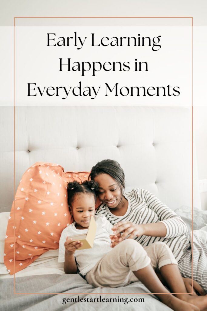 A parent and young child reading together on a bed, showing early learning at home through quiet, connected everyday moments.