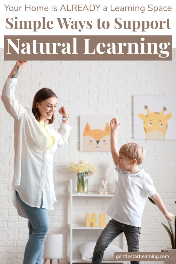 A mom and young child dance together in a bright, cozy room, showing the joy and connection that make home a natural learning space.