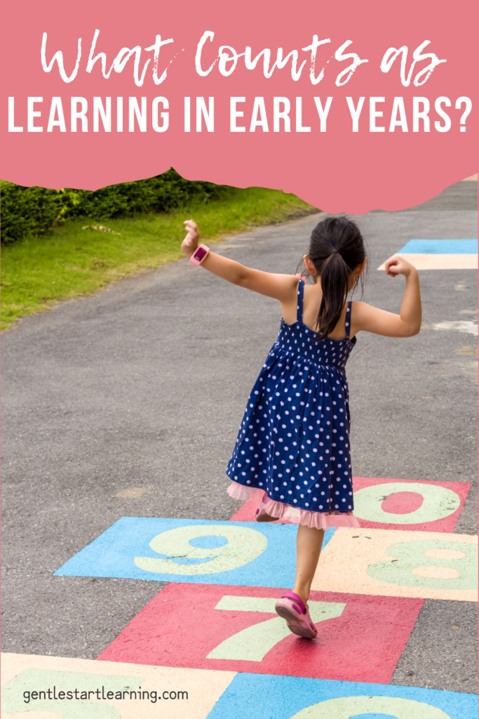 A young child jumping on a colorful hopscotch path outdoors, illustrating what counts as learning in the early years through playful movement.